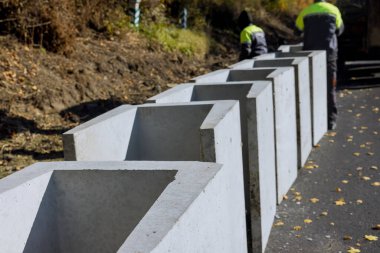 In order to water drain reconstruction road, precast concrete u-shaped drains were installed along road clipart