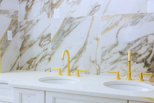 Beautifully remodeled master bathroom after renovation with marble sink