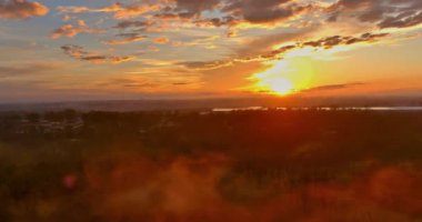 Sun sets in forest mountains of South Carolina at during heavy evening fog