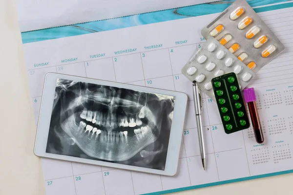 Panoramic dental x-ray is taken in order for doctor to prescribe an effective treatment for patient by reviewing results on digital tablet.