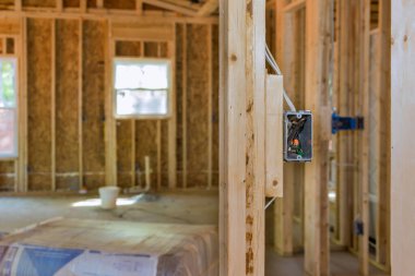Construction brand new residential building consisting framing wood frame house that is unfinished with basic electrical wiring