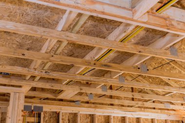 During construction of house, unfinished wood framing beams are used to frame walls