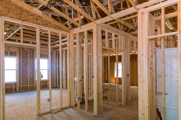 House framing beams form framework for unfinished wood frame of residential construction