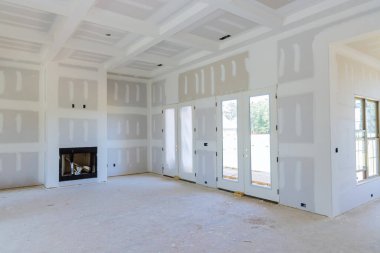 As part of construction new house, we are finishing plastering drywall ready to paint clipart