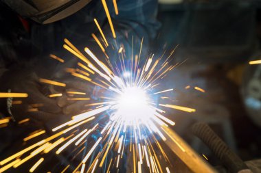 Using semiautomatic argon gas shielded welding semi-automatic machine worker works welding metal