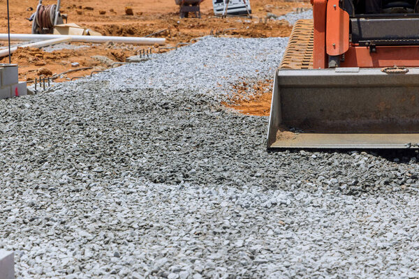 Excavator bucket filled with crushed stone excavator is uploading full bucket of crushed stone into bucket