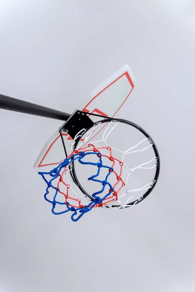 On white background basketball basket hoop is placed in top of rim with net hanging from it