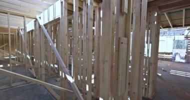 Wood frame unfinished for residential construction is framed by framing beams