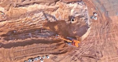 Construction site excavation trenches are dug for sewer pipes to connected underground storm sewer system pipes