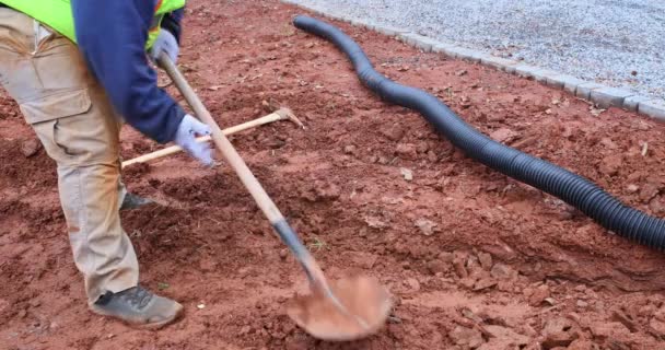 While Heavy Rainfall Occurring Worker Digs Trench Laying Drainage Pipe — Stockvideo