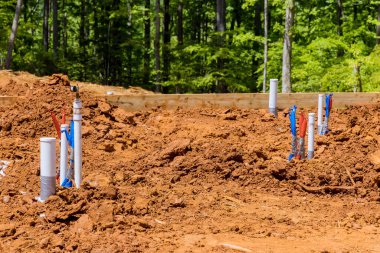 Involves installation of new utility sewer and water lines under foundation new home as well as laying utility pipes