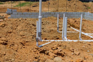 Utility sewer pipe and water pipe will be laid under foundation of new home, laying under foundation.