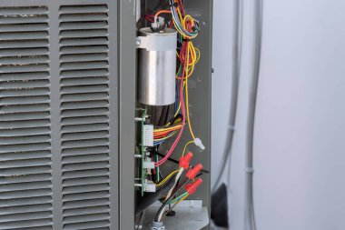 Outside air conditioning system unit installed on exterior facade of house