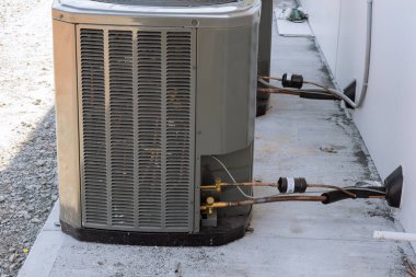 There is an air conditioning unit installed on near house as part of outside air conditioning system