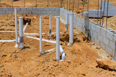 New home is being constructed in which underground utility pipes sewers and water lines will be buried under foundation