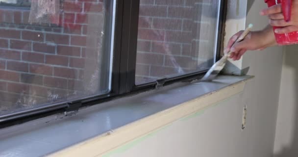 Using Paintbrush Repairman Paints Window Molding Trim Renovations Apartment — 图库视频影像