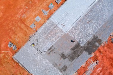 Polyethylene should be laid for waterproofing before concrete is poured on foundation