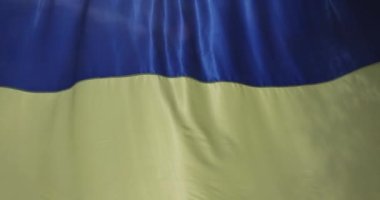 UA national flag of Ukraine is curved flag made up blue and yellow fabric which is waving in air
