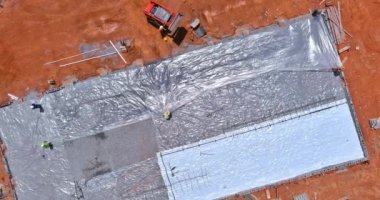 Polyethylene is laid down as waterproofing layer before concrete is poured into foundation