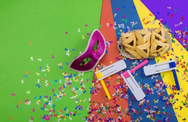 Enjoy eating hamantaschens and celebrating with carnival masks in commemoration saving Jews from Haman evil plan.