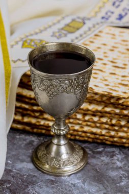 Cup of kosher kiddush wine is served with kosher matzah bread during Passover.