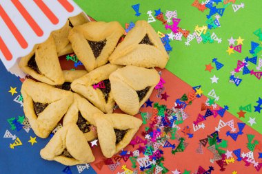 Many families bake hamantaschen cookies together as way to commemorate Jewish holiday enjoy sweet treat.