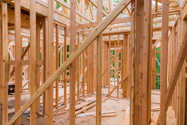 stock image Construction of stick house involves assembling timber beams into truss frames.