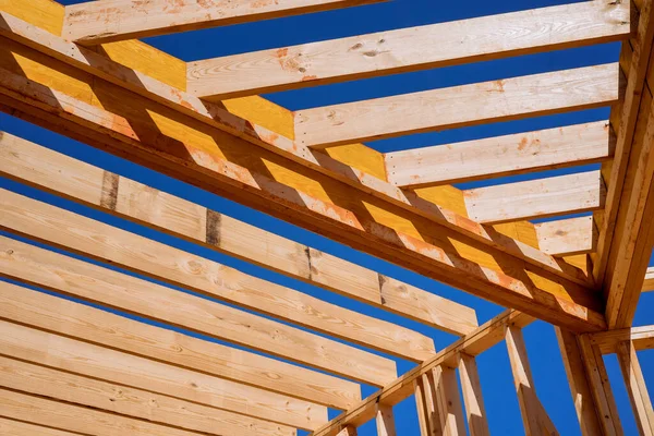 stock image During construction of newly constructed wooden house framing beam supports framework construction layout joists.