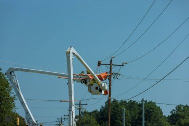 As a result of storm, electrical workers in the power pole maintenance industry were hired to repair damaged power lines.