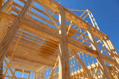 The wooden beams sticks that being used to build a new house are being installed
