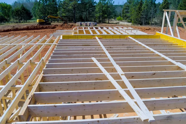 stock image During construction of newly constructed wooden house framing beam supports framework construction layout joists.