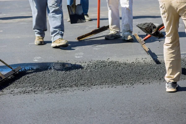 Construction worker laying new asphalt roads as part process of asphalting