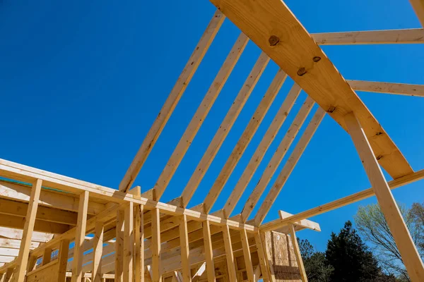 Installation of wooden roof beam over an already built stick home with use framework trusses