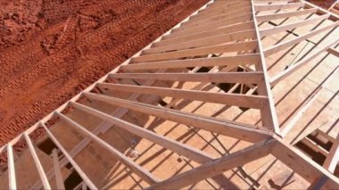 Roofing framework for beam stick home was constructed using trusses during construction of new home
