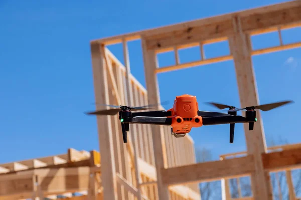 An inspector checks quality of construction works on construction site with help drone