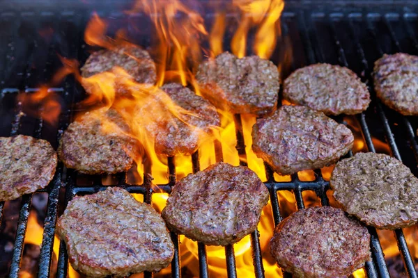 Using bbq fire flame grill for grilling of grilled beef meat barbecue burgers for hamburgers