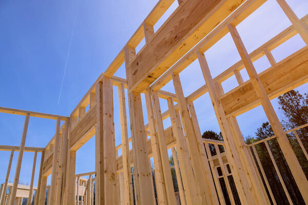 In construction of new home frame house is built with wooden beams sticks