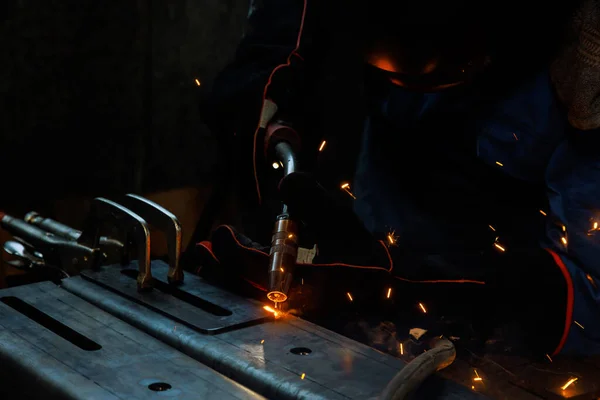 stock image During welding of steel at work in factory, spark is lighting smoke workplace