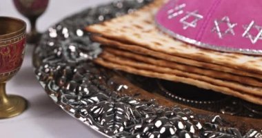 Jewish holiday Passover is kosher unleavened matzah bread and cup of kosher kiddush wine for Pesach