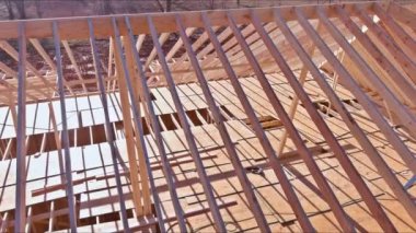 Wooden roof framework from trusses was constructed as part construction of new beam stick to home