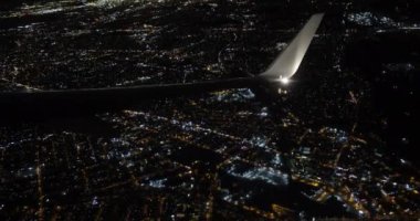 Mesmerizing sight greeted passengers as airplane flew over sprawling night city.