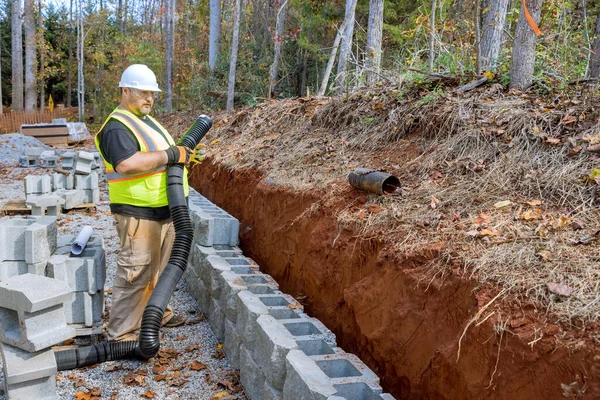 stock image Process of laying drainage pipe for rainwater in retaining wall to prevent water buildup.