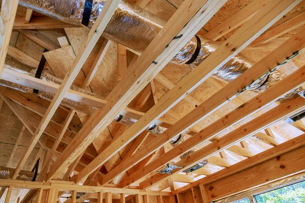 stock image Wooden beamed ceiling in new home gains prominence with installation of central HVAC system.