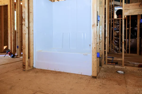 stock image Emerging home with new bathroom showcasing acrylic bathtub installed between a beams frame