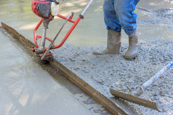 Concrete driveway tamping machine for compacted layer alignment in construction site