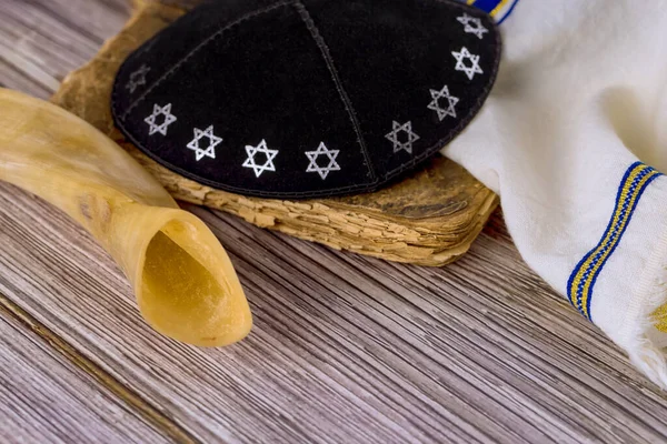 Shofar and prayer book on prayer shawl tallit kippah for jewish holiday in synagogue