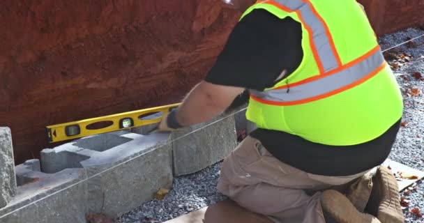 Working Diligently Construction Worker Affixed Concrete Block Retaining Wall — Stock Video