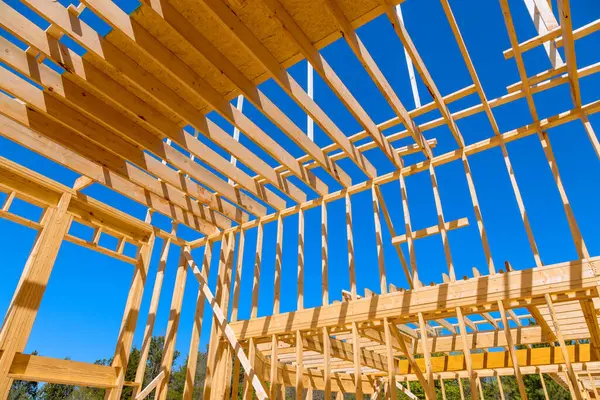 stock image In construction new house roof, wooden frame trusses are used as support beams