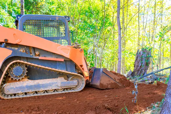 stock image On construction site, tractor is leveling ground for construction of house