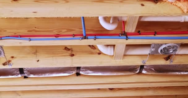 New House Worker Installs Plumbing System Electrical Wires Ceiling Light — Stock Video